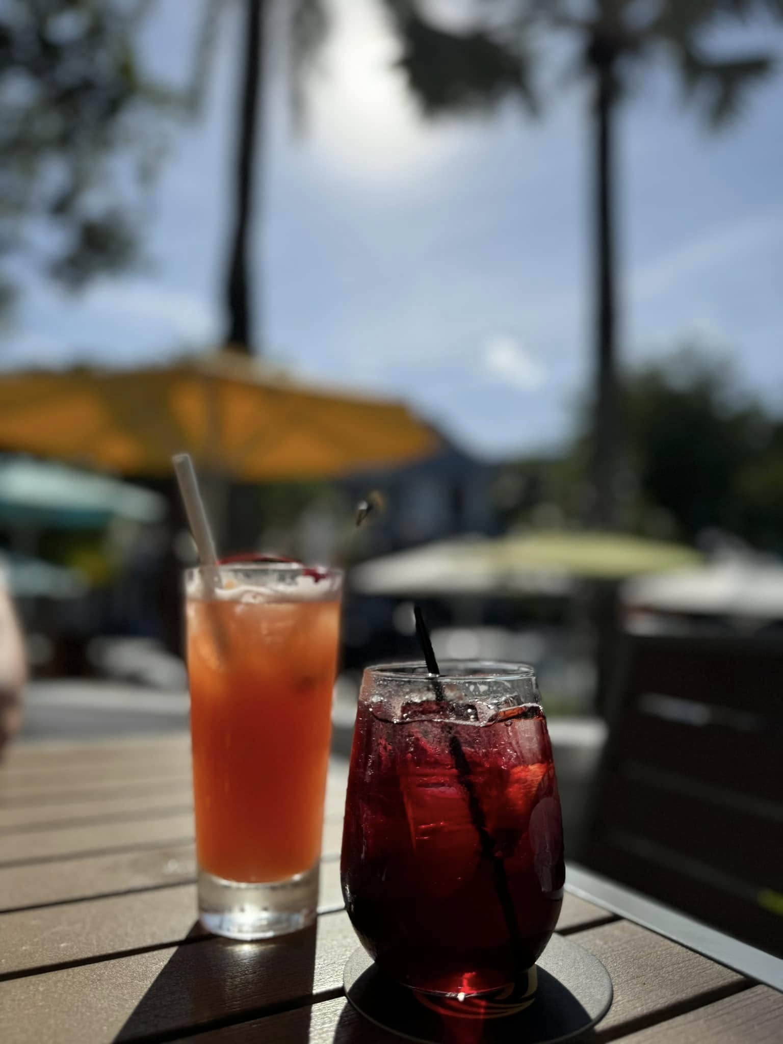 Two cocktails on a sunny outdoor patio under umbrellas in Key West, Florida